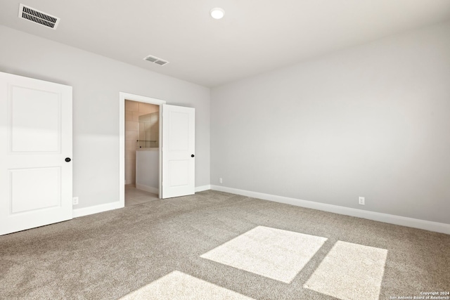 unfurnished bedroom with a walk in closet, carpet floors, and a closet