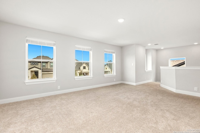 unfurnished room featuring light carpet