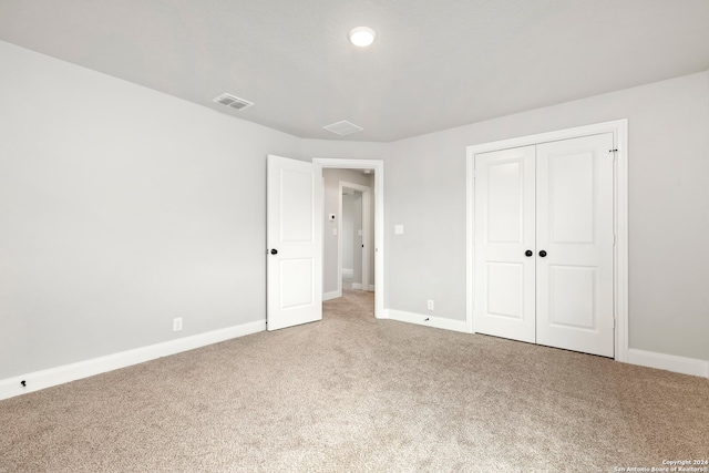 unfurnished bedroom with carpet and a closet