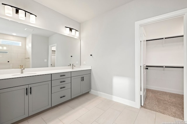 bathroom featuring tile patterned floors, vanity, and tiled shower