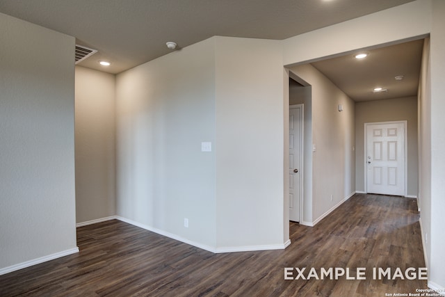 spare room with dark hardwood / wood-style flooring