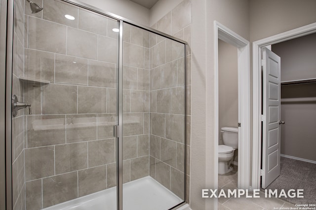 bathroom featuring toilet and an enclosed shower