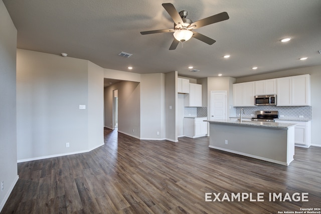 kitchen featuring light stone countertops, an island with sink, stainless steel appliances, white cabinets, and dark hardwood / wood-style floors