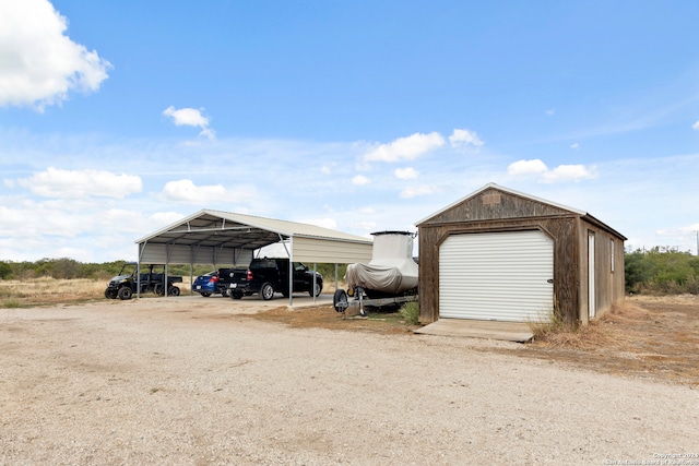 view of outbuilding featuring a garage and a carport