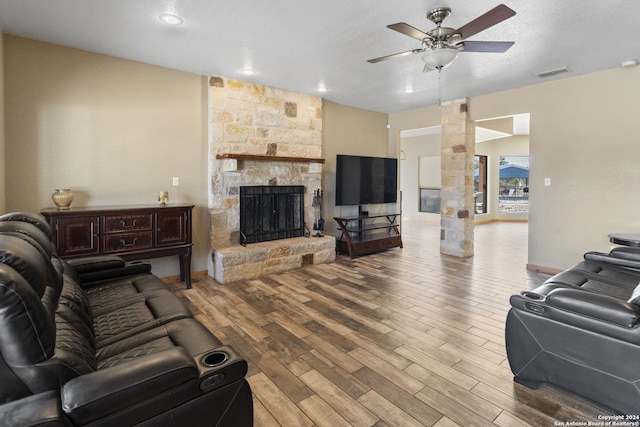 858 Ranch Rd 187, Sabinal, TX 78881 - living area with ceiling fan, a fireplace, recessed lighting, wood finished floors, and visible vents