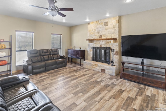 858 Ranch Rd 187, Sabinal, TX 78881 - living area featuring a stone fireplace, a ceiling fan, recessed lighting, and wood finished floors