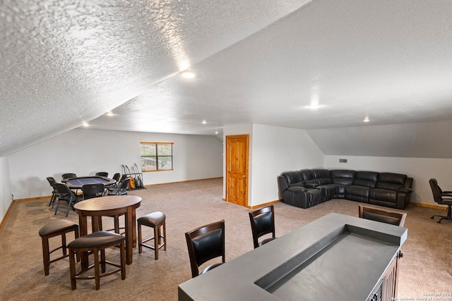 recreation room with lofted ceiling, a textured ceiling, and carpet floors