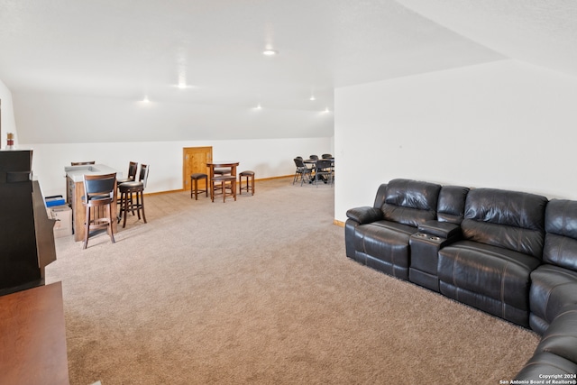 living room featuring lofted ceiling and light colored carpet