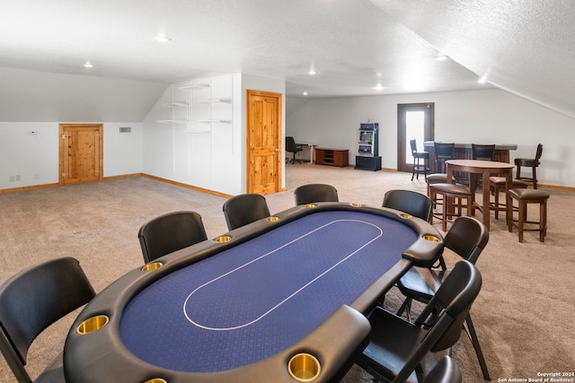 playroom featuring a textured ceiling, lofted ceiling, and light colored carpet