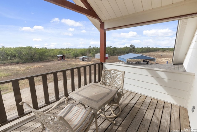 858 Ranch Rd 187, Sabinal, TX 78881 - wooden deck featuring an outbuilding
