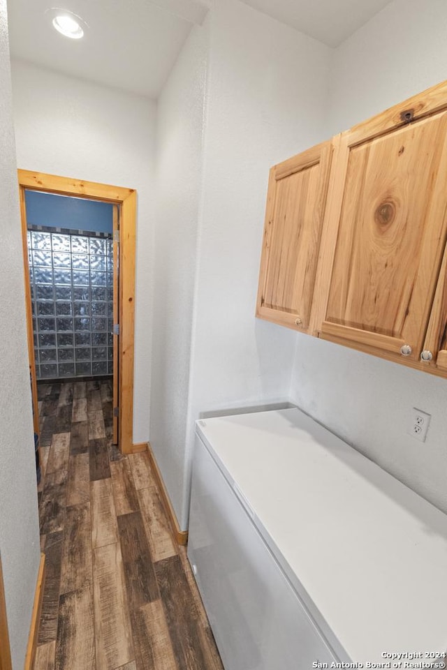 858 Ranch Rd 187, Sabinal, TX 78881 - washroom with dark wood-type flooring, cabinet space, washer / clothes dryer, and baseboards