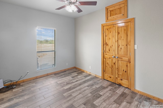 unfurnished room with hardwood / wood-style flooring and ceiling fan