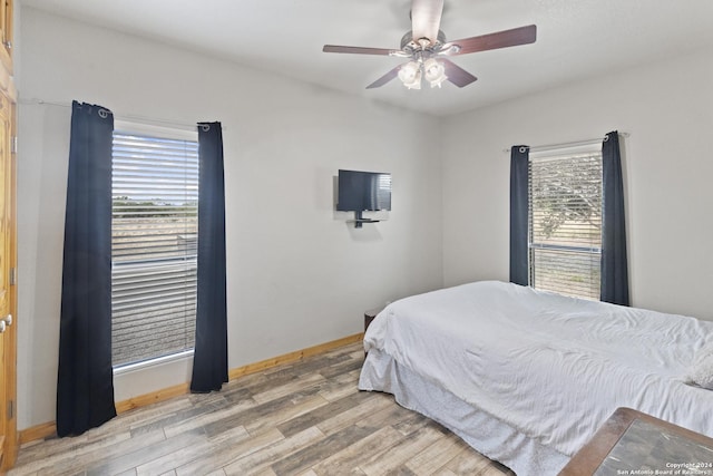 858 Ranch Rd 187, Sabinal, TX 78881 - bedroom featuring baseboards, ceiling fan, and light wood finished floors