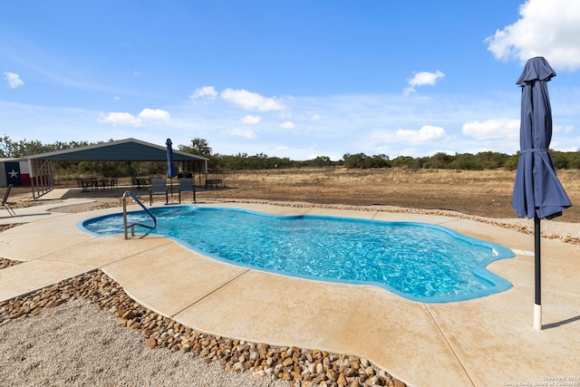 view of swimming pool featuring a patio