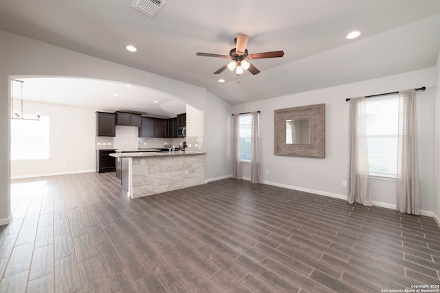 unfurnished living room with sink, ceiling fan, lofted ceiling, and dark hardwood / wood-style flooring