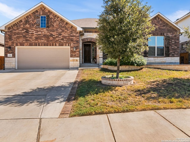 front of property featuring a front yard and a garage