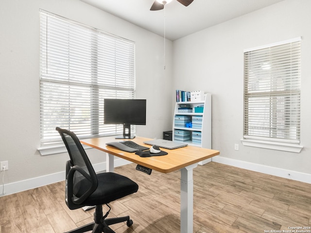 office area with light hardwood / wood-style floors and ceiling fan