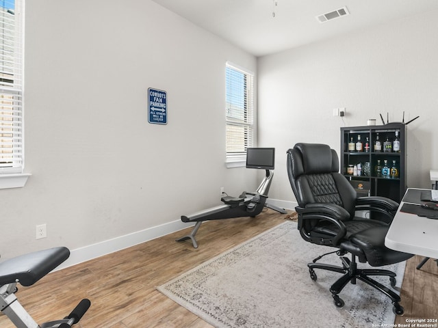 office space with wood-type flooring