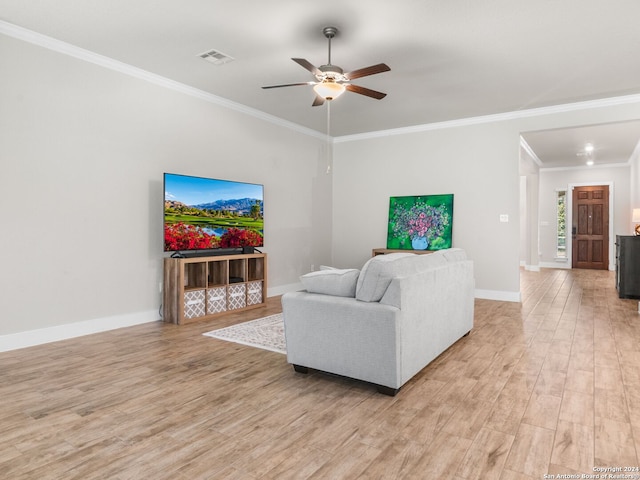 living room featuring light hardwood / wood-style floors, ornamental molding, and ceiling fan