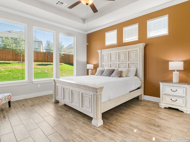 bedroom with multiple windows, crown molding, and ceiling fan