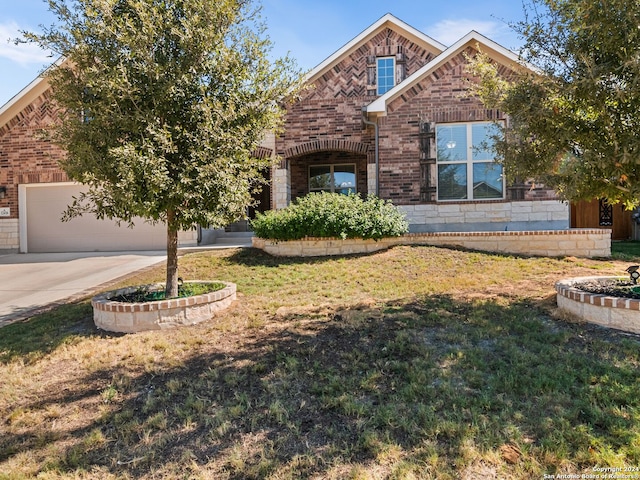 view of front facade with a front yard and a garage