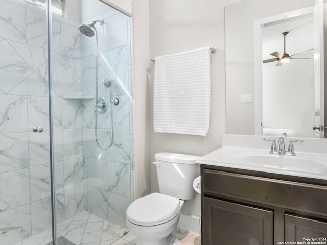 bathroom featuring vanity, walk in shower, toilet, and ceiling fan