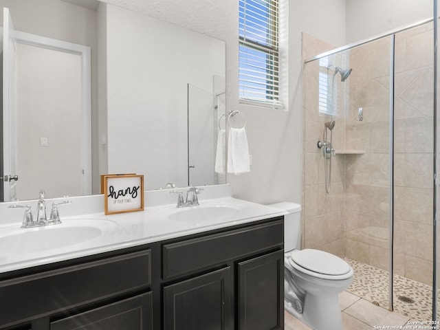 bathroom featuring vanity, toilet, and walk in shower