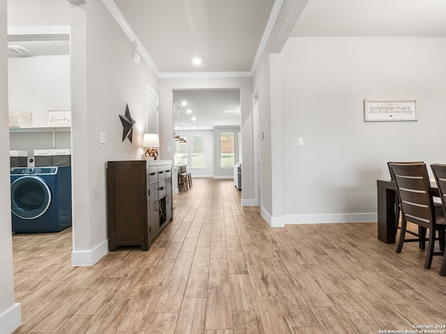 interior space featuring washer / dryer, light hardwood / wood-style floors, and ornamental molding