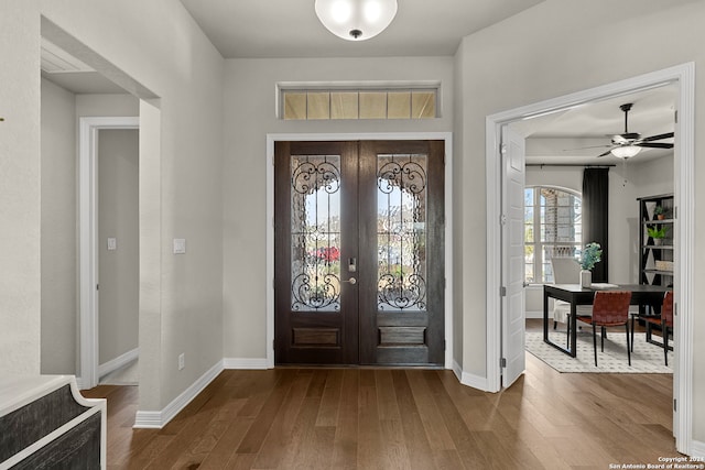 foyer featuring french doors, ceiling fan, and hardwood / wood-style floors