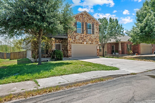 view of front of property featuring a front yard and a garage