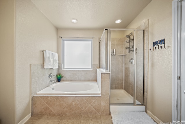 bathroom featuring tile patterned floors, independent shower and bath, and a textured ceiling