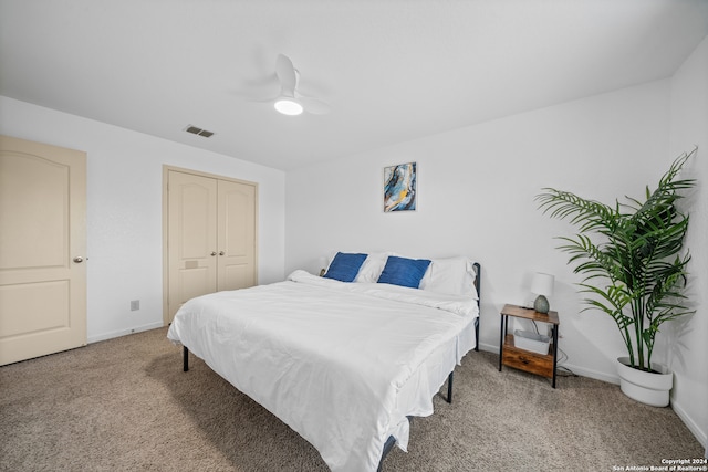 carpeted bedroom with a closet and ceiling fan