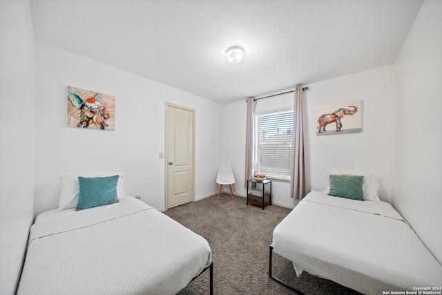 carpeted bedroom featuring a textured ceiling