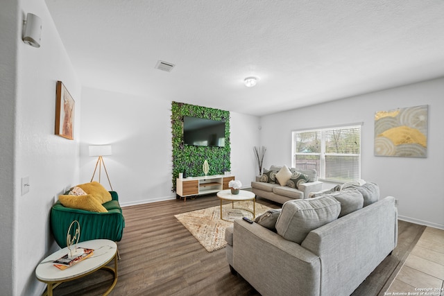 living room featuring a textured ceiling and hardwood / wood-style flooring