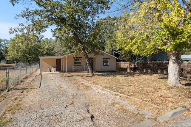 view of front of property with stucco siding and a fenced backyard