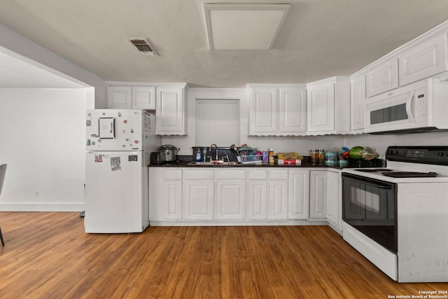 kitchen featuring white cabinetry, white appliances, light wood-style floors, and a sink