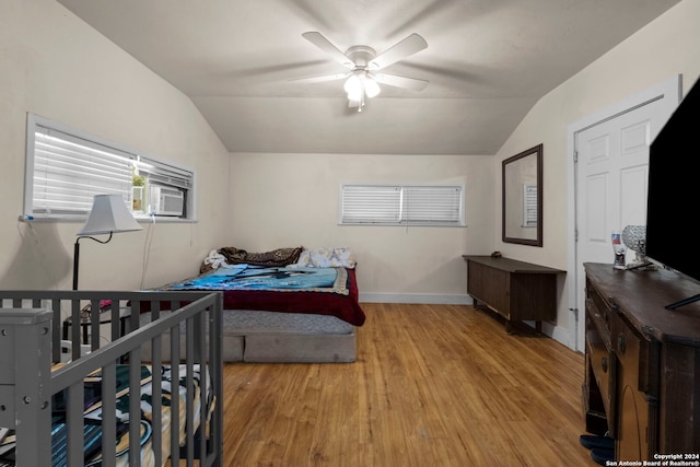 bedroom featuring a ceiling fan, light wood finished floors, vaulted ceiling, and baseboards