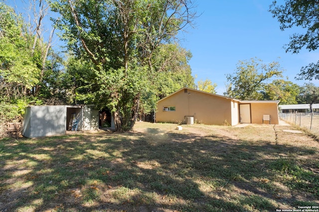 view of yard with an outdoor structure and fence