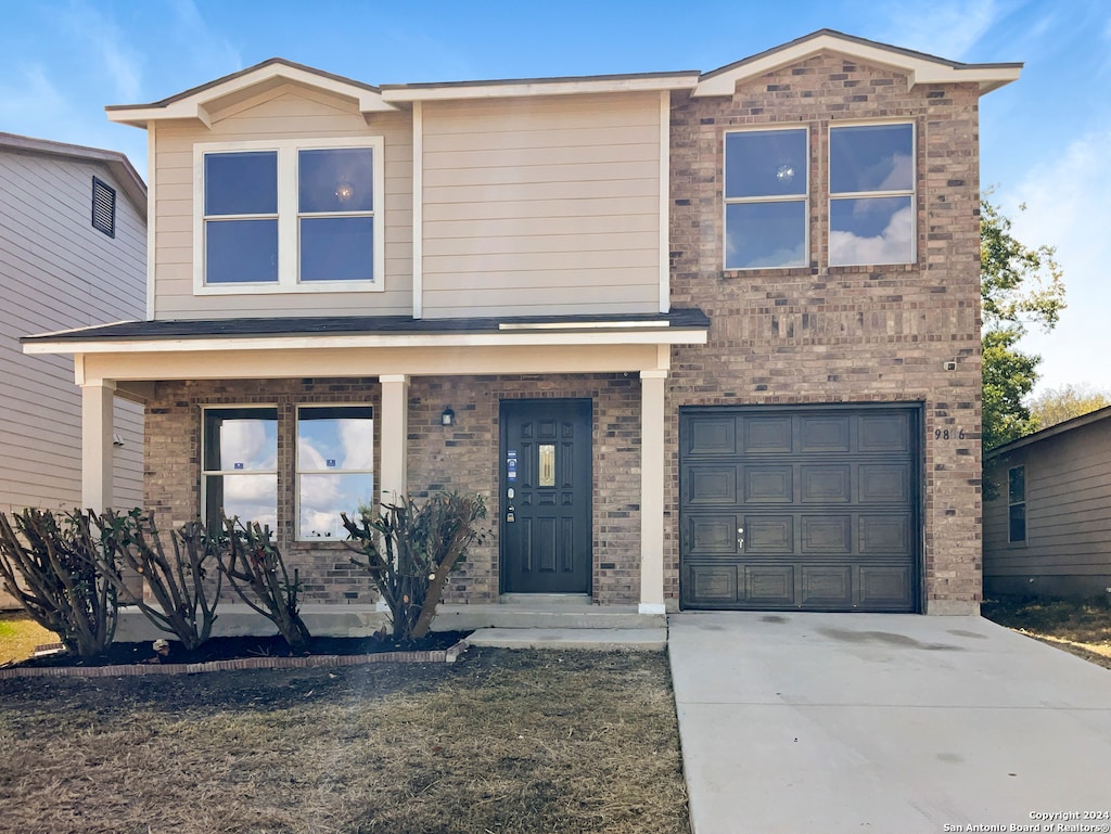 view of front of property featuring covered porch and a garage