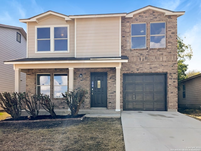 view of front of property featuring covered porch and a garage