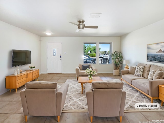 living room featuring light tile patterned floors and ceiling fan