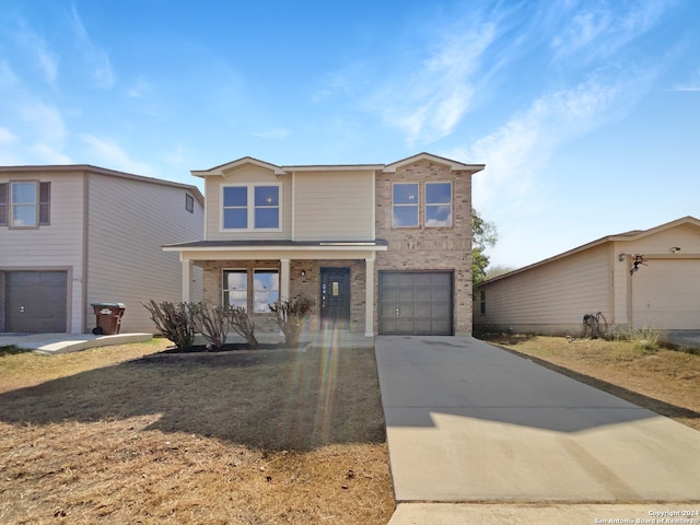 front of property with covered porch and a garage