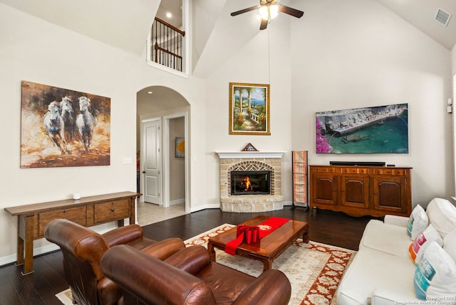 living room with ceiling fan, high vaulted ceiling, a fireplace, and hardwood / wood-style floors