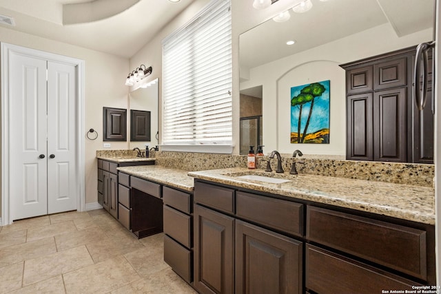 bathroom featuring vanity and a shower with door