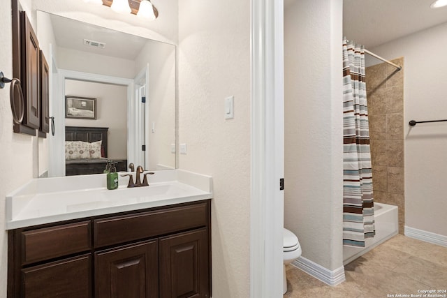 full bathroom featuring toilet, vanity, tile patterned floors, and shower / tub combo