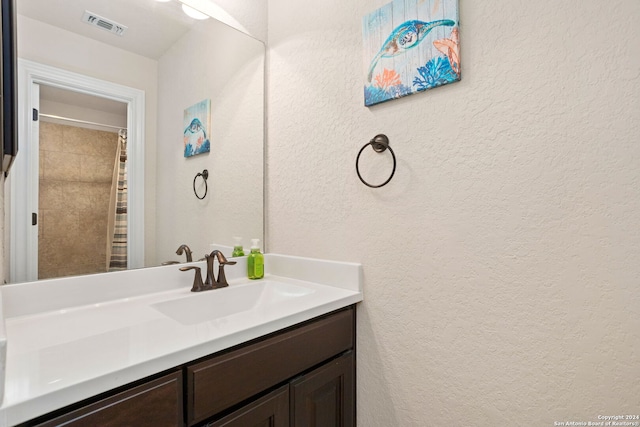 bathroom with vanity and curtained shower