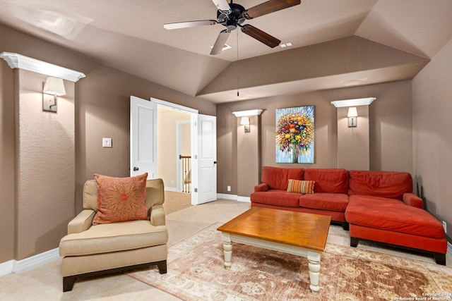 carpeted living room with vaulted ceiling and ceiling fan