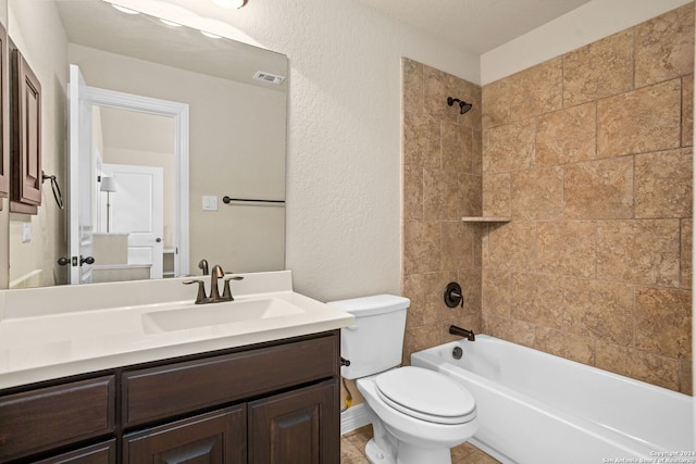 full bathroom with vanity, tiled shower / bath combo, and toilet