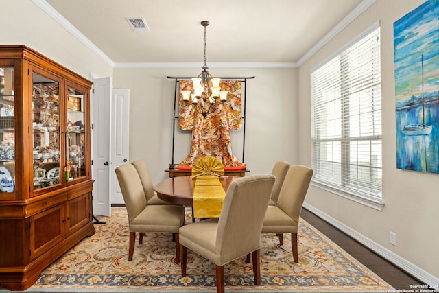 dining room featuring crown molding, a chandelier, and plenty of natural light