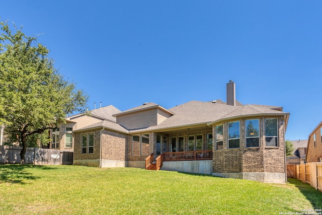 back of property with a yard, covered porch, and central AC unit